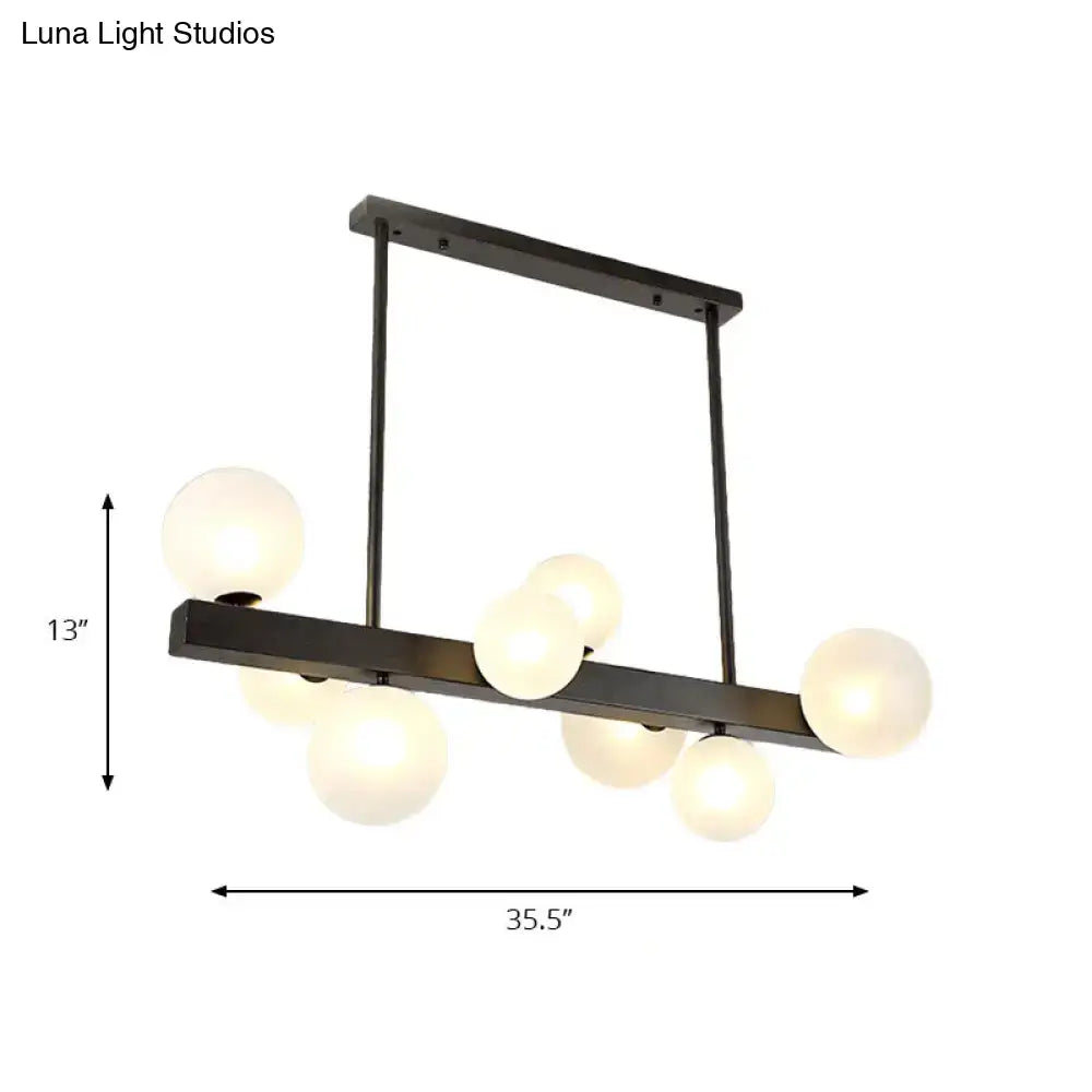 Modern black metal chandelier with six frosted glass globe bulbs ideal for dining room lighting by DecorBites™