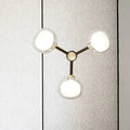 Modern black and gold three-light wall lamp with frosted glass shades for stylish bedroom lighting