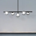 Modern black metal ceiling light with five bubble clear glass globe bulbs for a clear glass island dining room