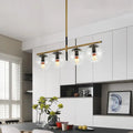 Modern black and gold pendant light with four clear glass globe shades and exposed filament bulbs 110v-240v compatible