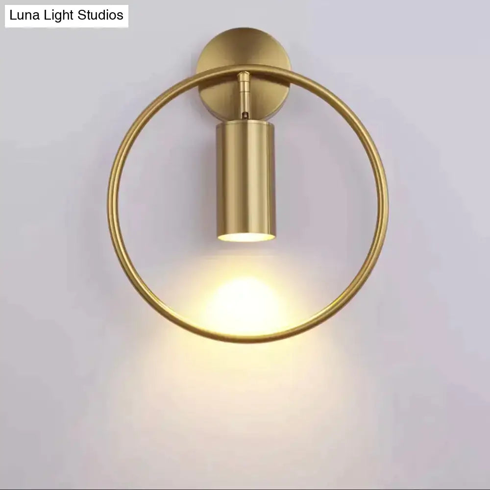 Gold-finished modern irwin wall lamp with circular ring and cylindrical light fixture for bedroom sconce lighting