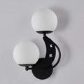 Modern black crescent wall lamp with milky glass ball shades and star cutouts for elegant bedroom lighting