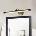 Modern black and gold wall light fixture with matte black cylindrical bar and ornate gold base for dressing table