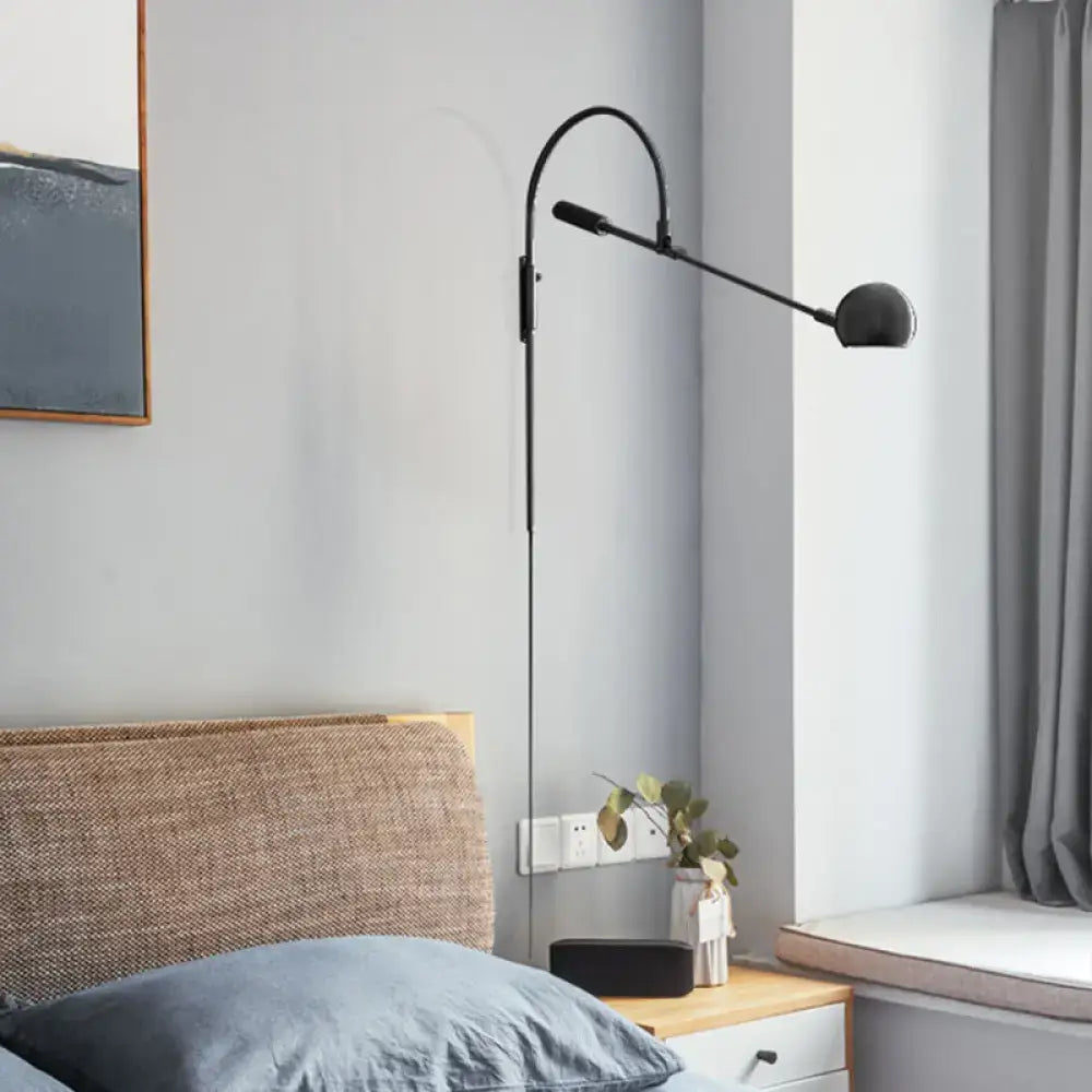 Modern black metal sphere wall sconce with curved arm bedroom light