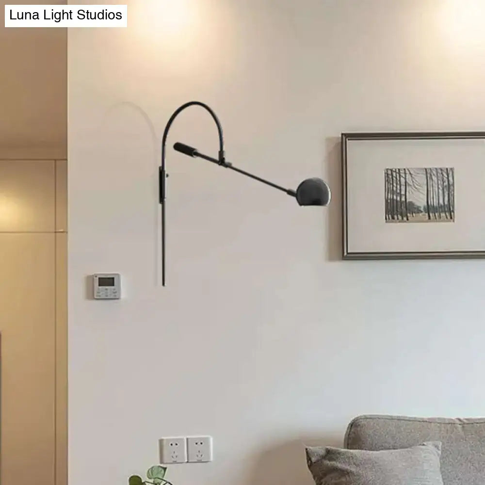 Modern black metal sphere wall sconce with curved arm bedroom light
