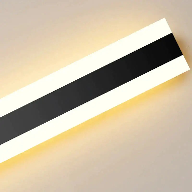 Modern black vertical led wall sconce with bold black and white stripes emitting warm glow ip65 waterproof design