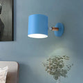 Modern blue metal tubular wall lamp with wood arm bedroom sconce light