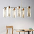 Modern brass 5 light chandelier with cognac glass shades and exposed bulbs perfect for dining room island light