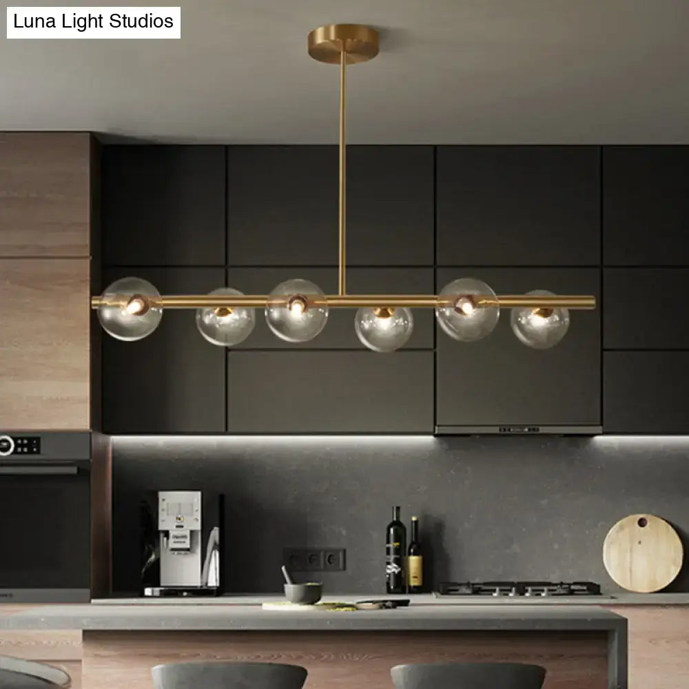 Modern brass 5-light pendant light featuring spherical glass shade globes designed for dining room lighting