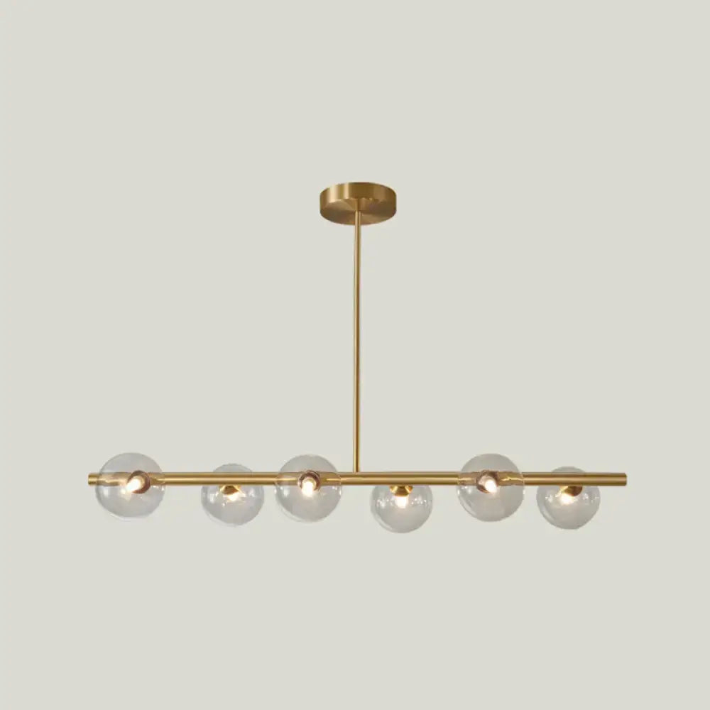 Modern brass 5-light pendant light with spherical glass shade dining room