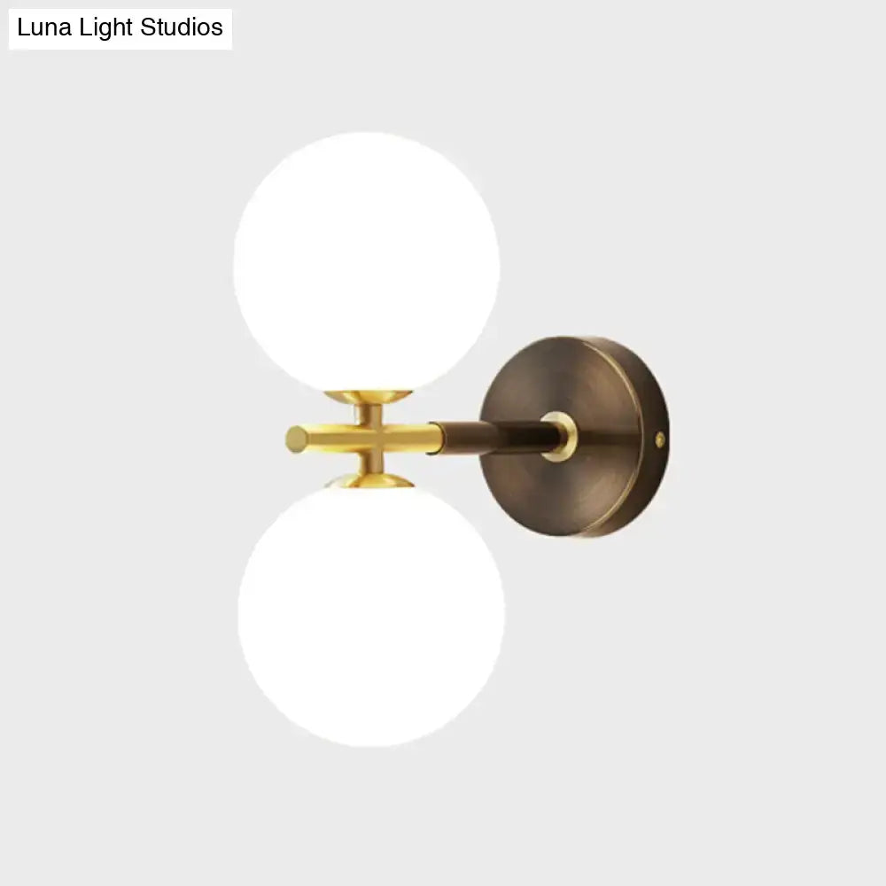 Modern brass and white glass wall sconce – bedroom globe light