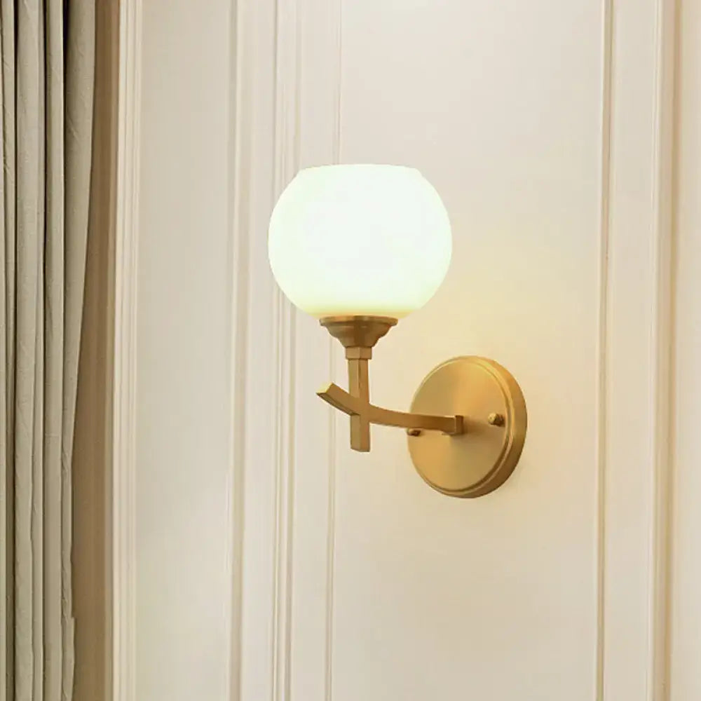 Modern brass armed sconce with opal glass shade bedroom wall lamp