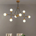 DecorBites™ brass finish island light with orb shade featuring six frosted glass globes for dining room use