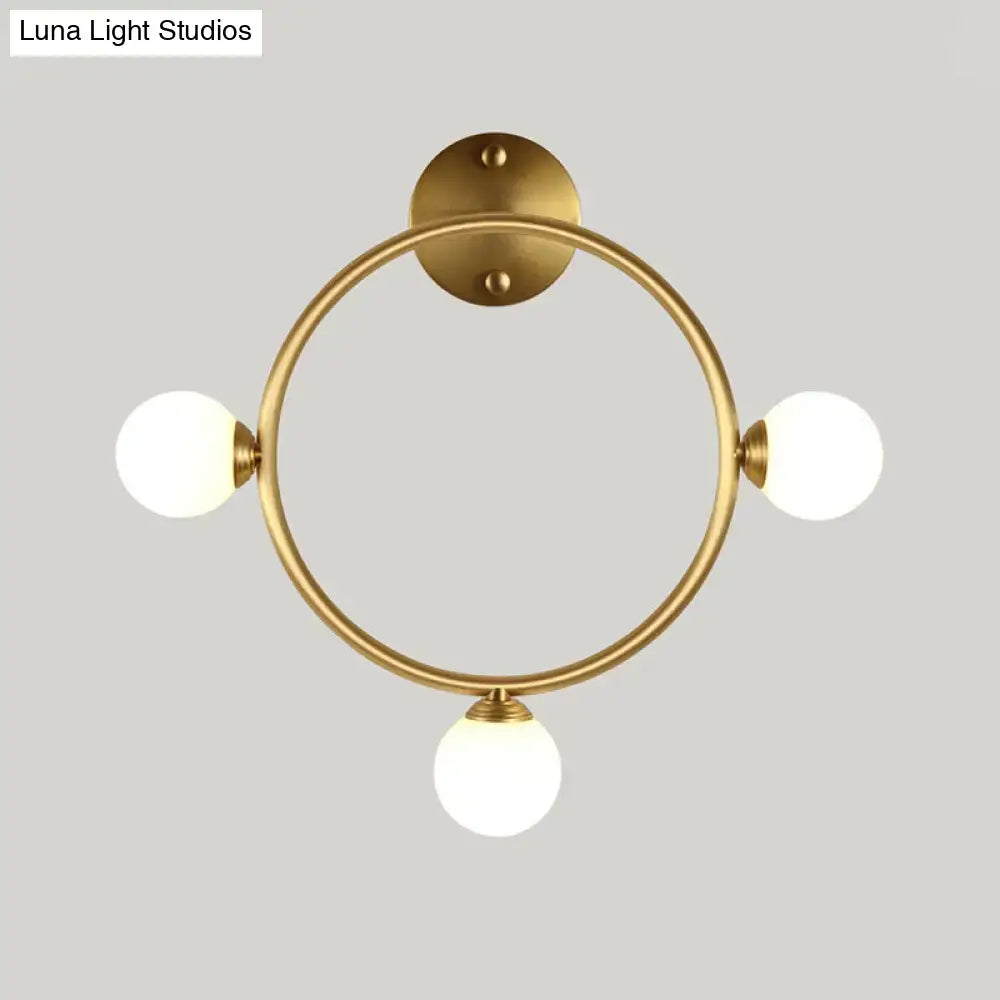 Modern brass circular wall light fixture with glass shades bedroom