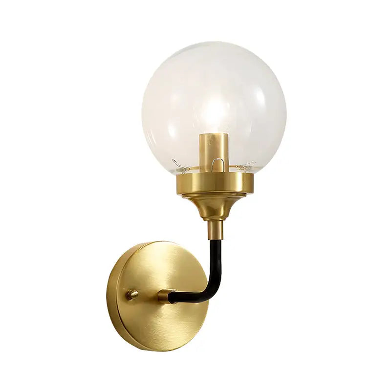 Modern brass curved arm wall sconce with clear glass for bedroom