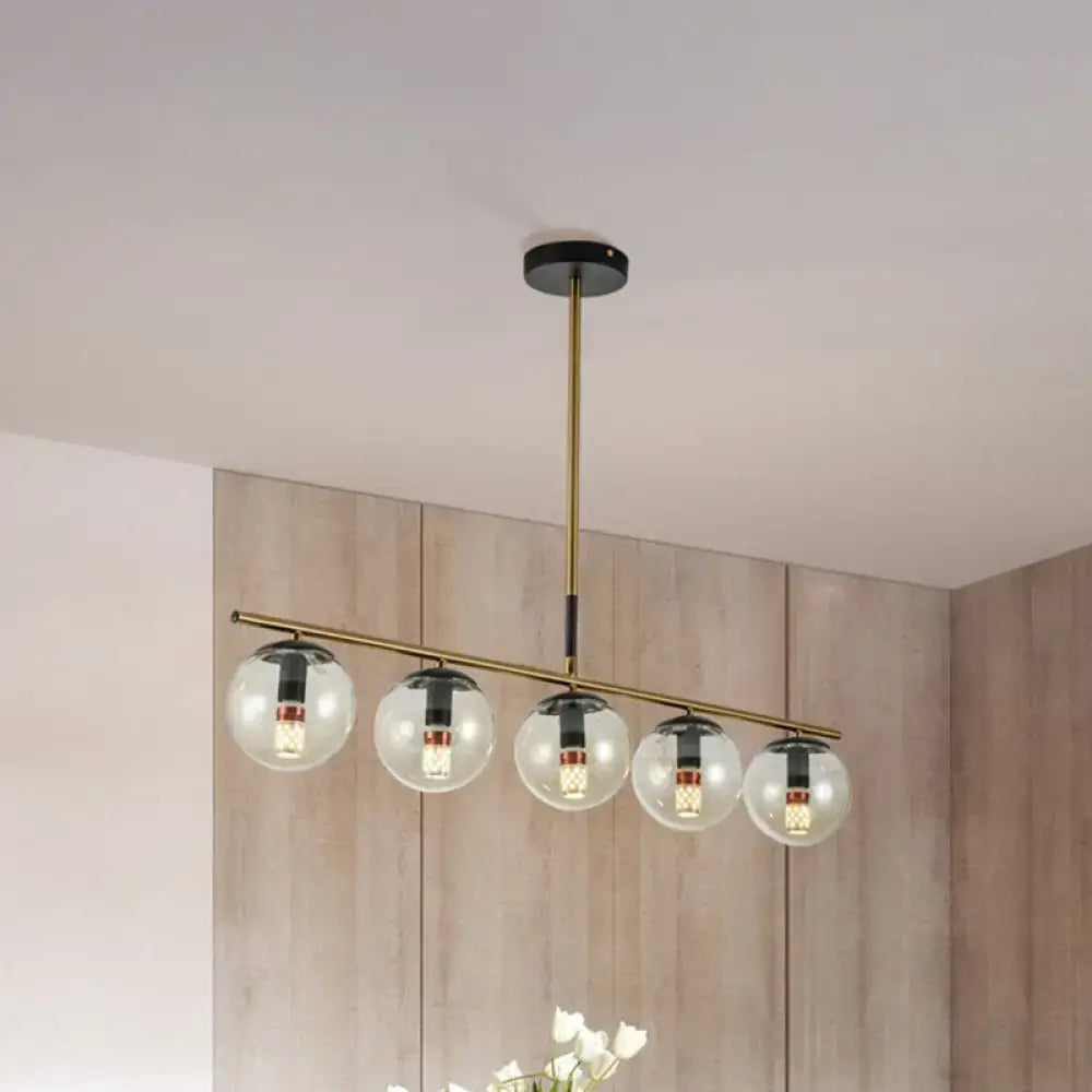 Modern brass dining room pendant light with cognac glass shades