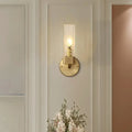 A sleek modern brass wall lamp with a clear textured glass cubic shade featuring e12 e14 light sockets