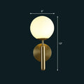 Modern brass glass globe wall mount light featuring a gold finish and frosted spherical glass for living room use