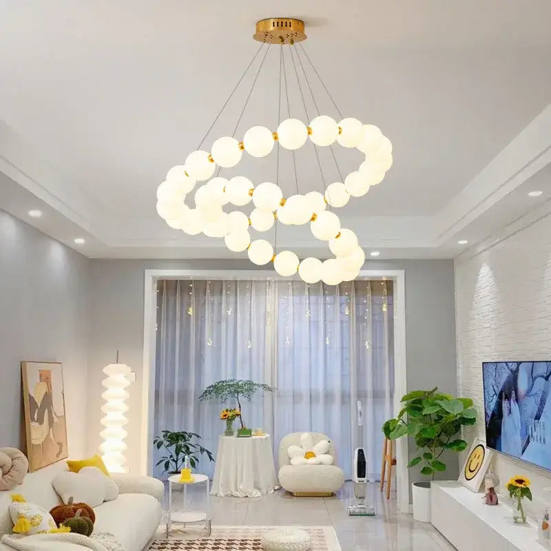 Modern brass led pendant light with frosted spheres for living room