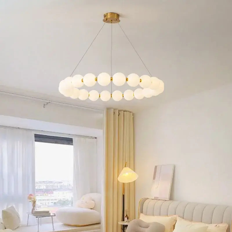 Modern brass led pendant light with frosted spheres for living room