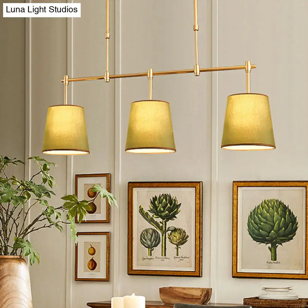 Modern brass pendant light with white green flaxen shades dining room