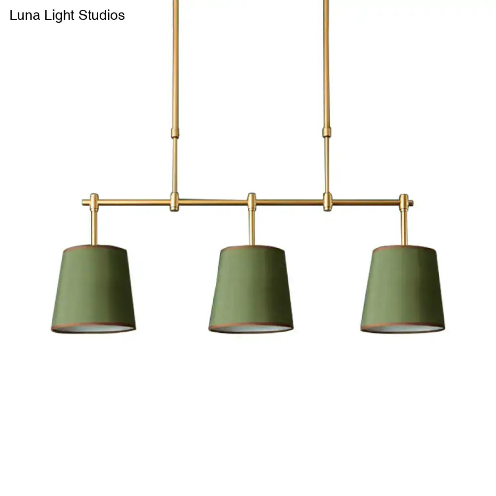 Modern brass pendant light with white green flaxen shades dining room