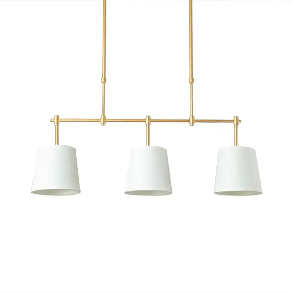 Modern brass pendant light with white green flaxen shades dining room