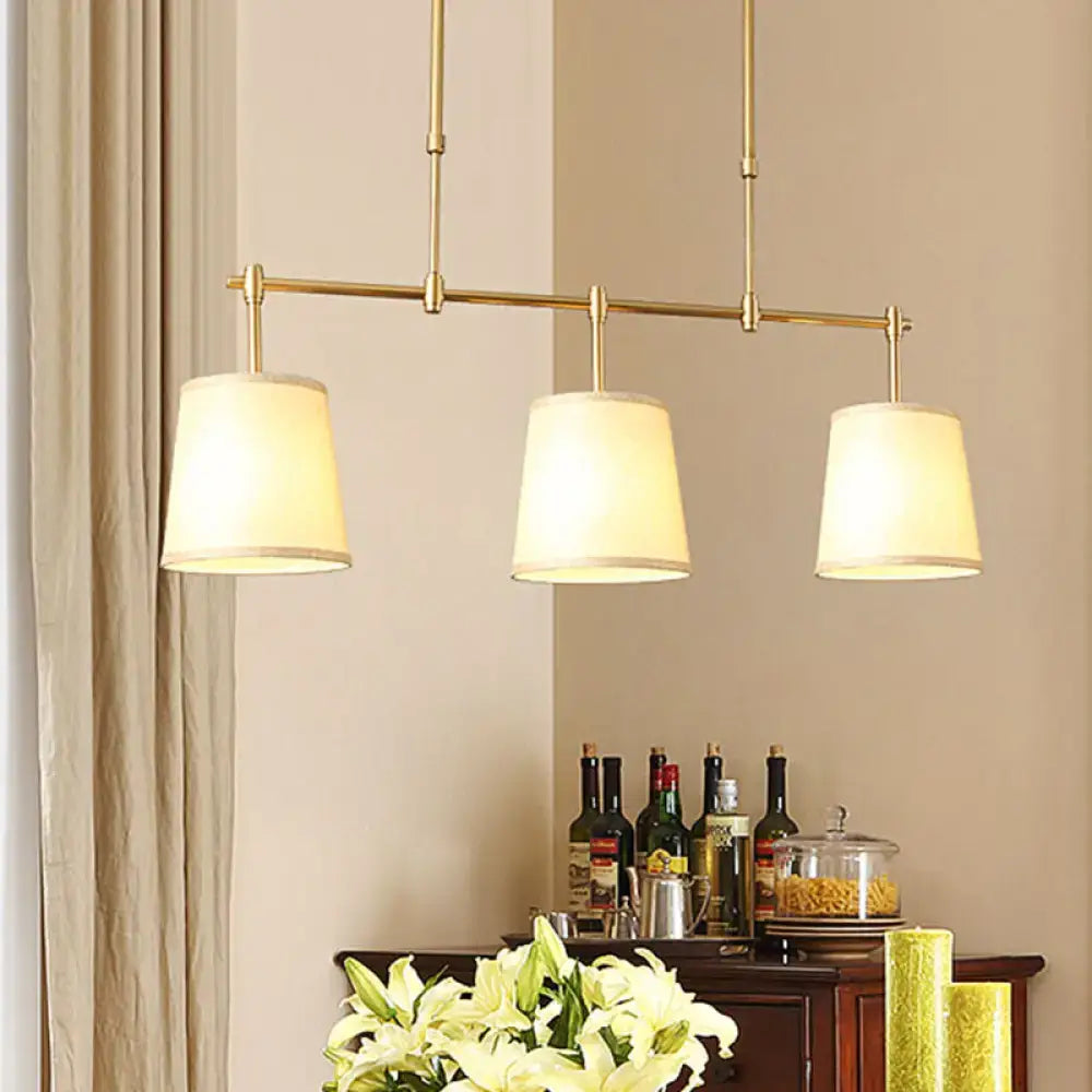 Modern brass pendant light with white green flaxen shades dining room