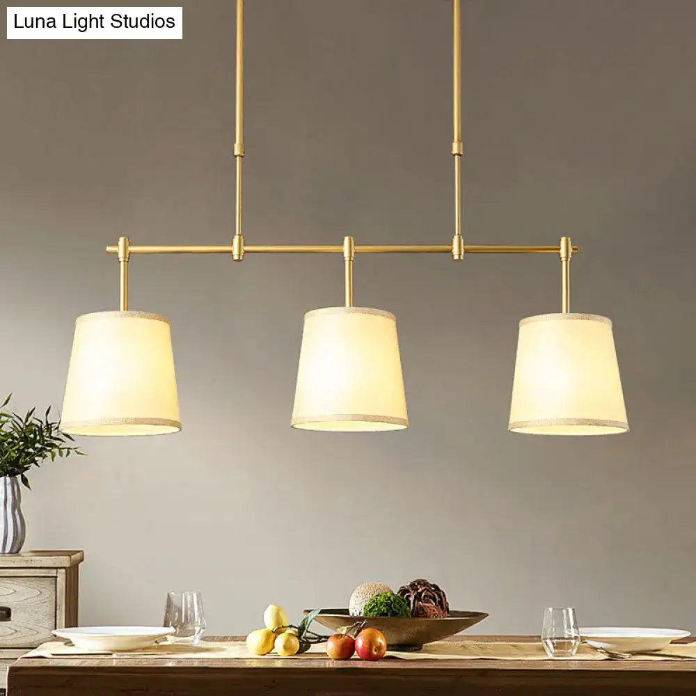 Modern brass pendant light with white green flaxen shades dining room