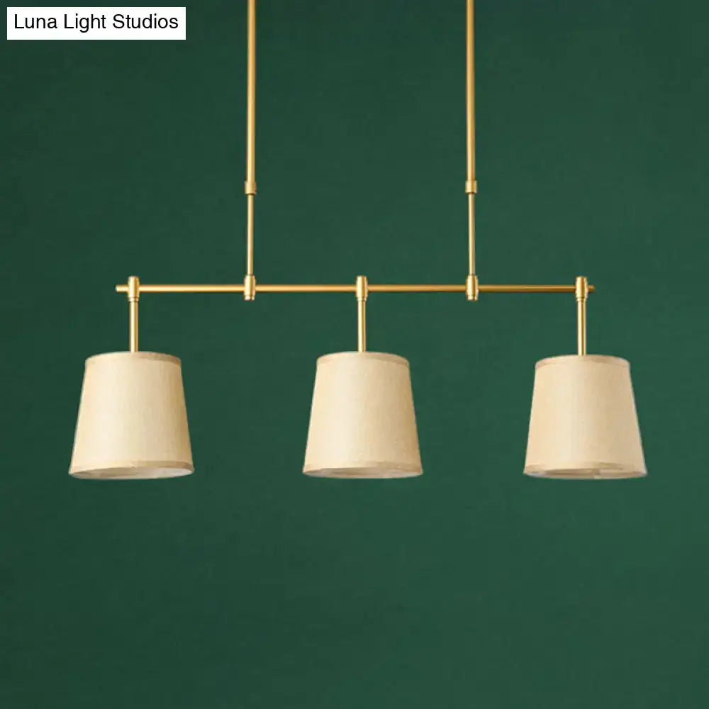 Modern brass pendant light with white green flaxen shades dining room