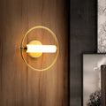 Modern brass ring wall sconce with opal glass shade bedroom light