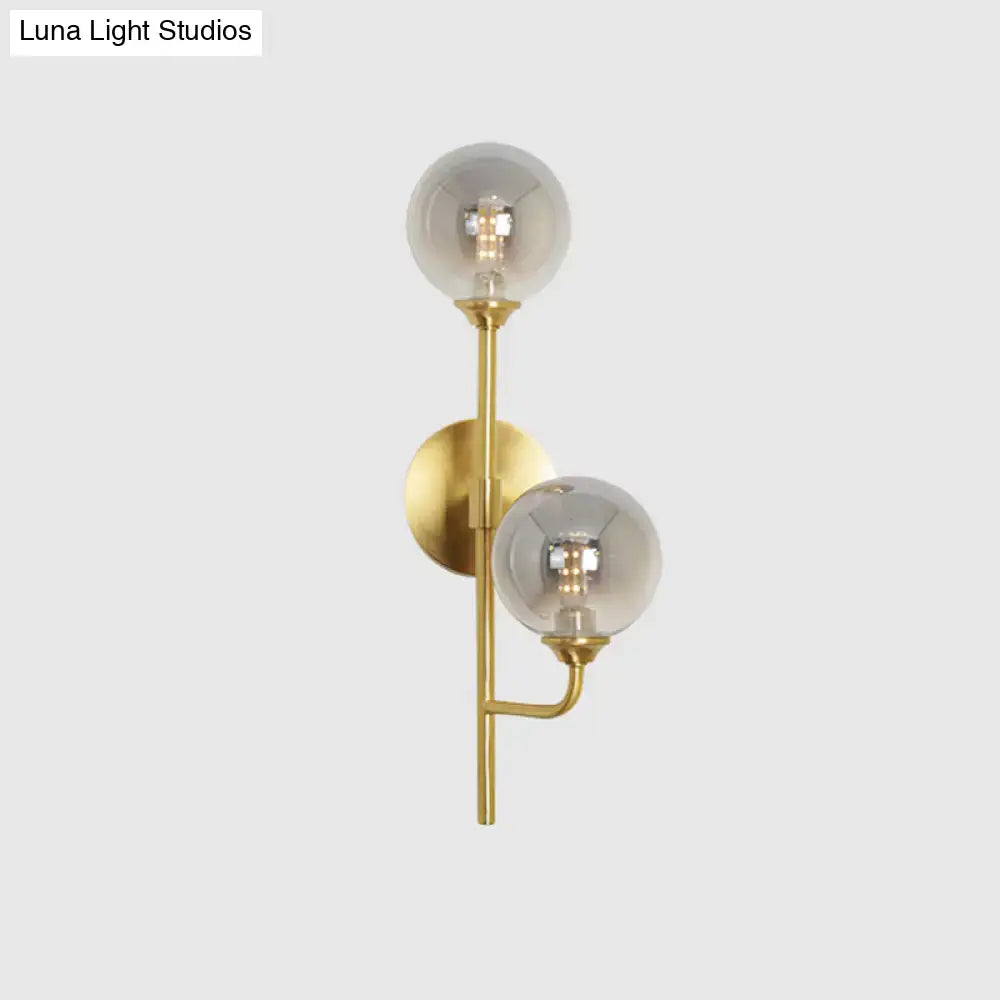 Modern brass sphere wall sconce amber & smoke gray bathroom light