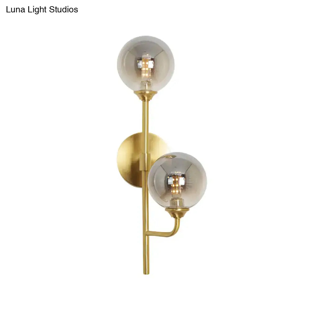 Modern brass sphere wall sconce amber & smoke gray bathroom light