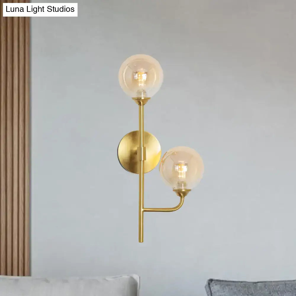 Modern brass sphere wall sconce amber & smoke gray bathroom light