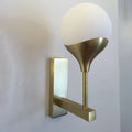 Modern brass wall lamp with cream glass shade – bedroom
