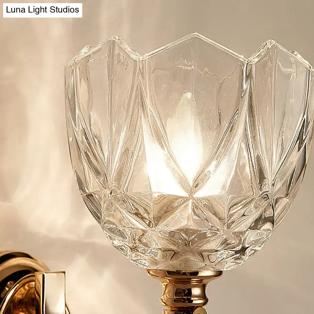 Modern brass wall sconce bedroom light with clear glass shade and gold toned faceted glass shade base