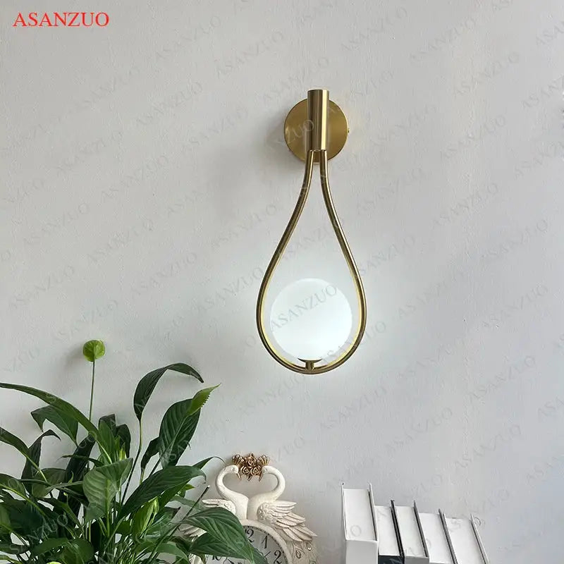 Modern brass wall sconce frosted glass teardrop living room light