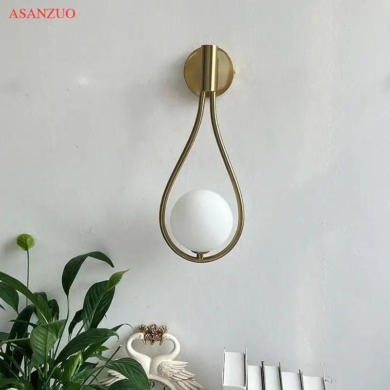 Modern brass wall sconce frosted glass teardrop living room light