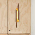Modern brown geometric metal shade wall sconce with warm golden glow crafted from metal and wood for living room light