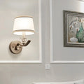 Modern brushed brass sconce light with clear crystal accent and white fabric shade for hallway wall light use