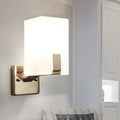 Modern brushed brass wall sconce with rectangular frosted glass shade for bedroom light type illumination