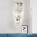 Modern chrome wall sconce light with clear glass shade featuring cascading crystal rods for bedroom lighting