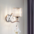 Modern chrome cylinder wall light with crystal block shade and white orchid ornament for bedroom use