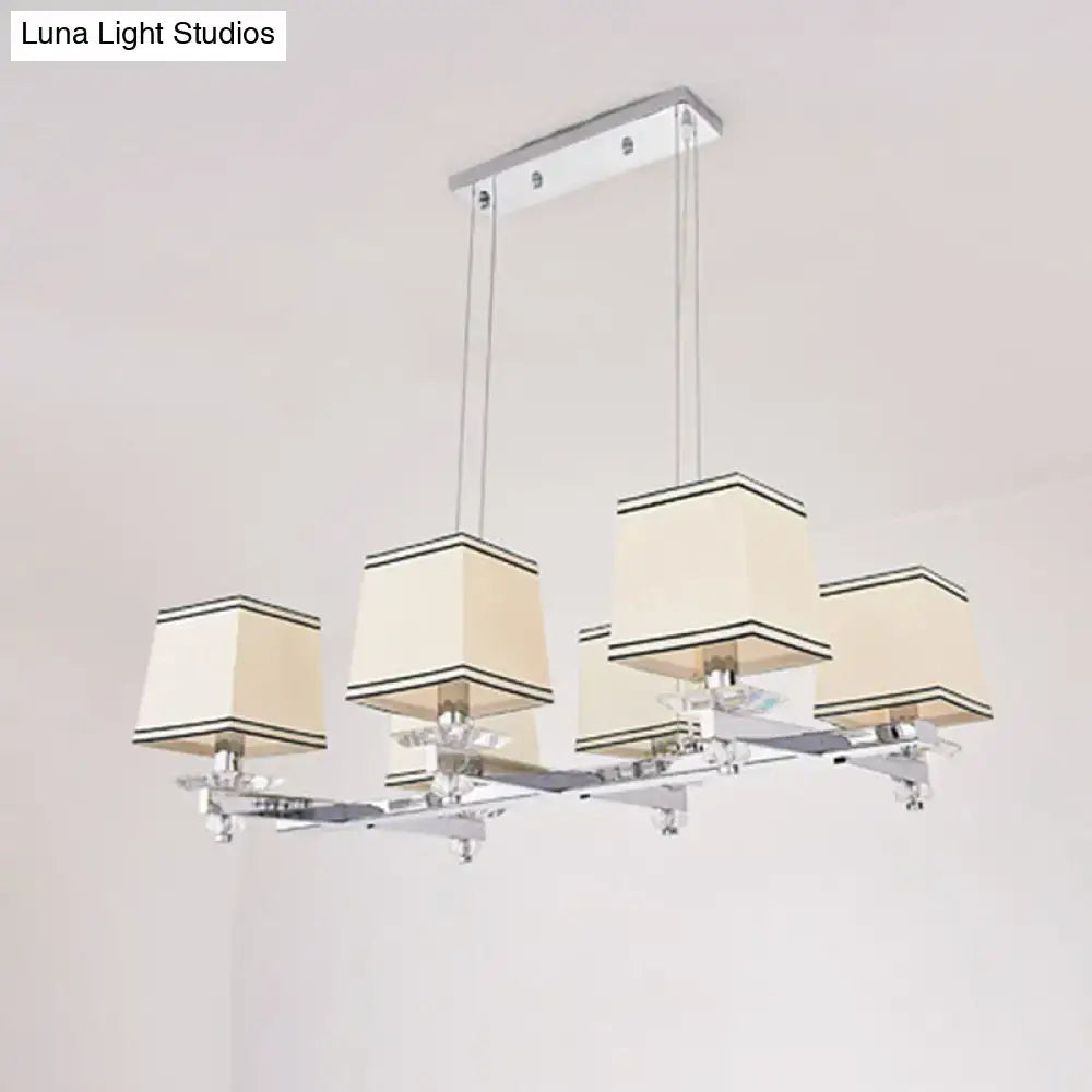Modern chrome island pendant light with cream shades for dining rooms