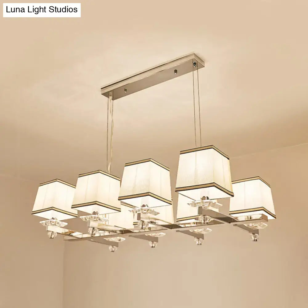 Modern chrome island pendant light with cream shades for dining rooms