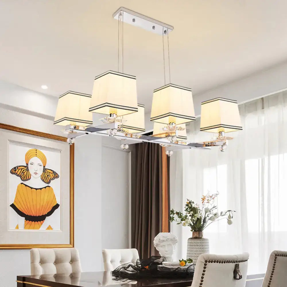Modern chrome island pendant light with cream shades for dining rooms