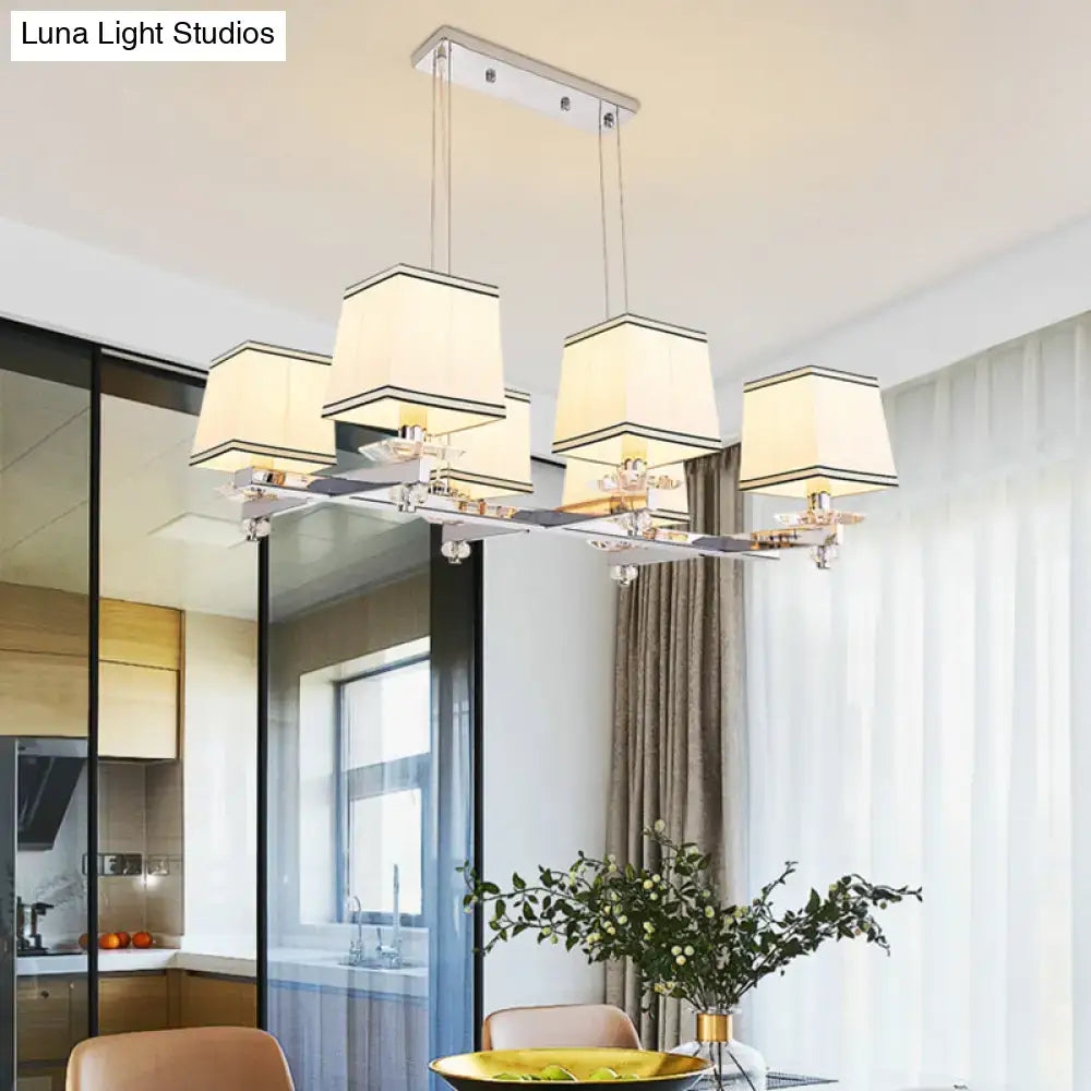 Modern chrome island pendant light with cream shades for dining rooms