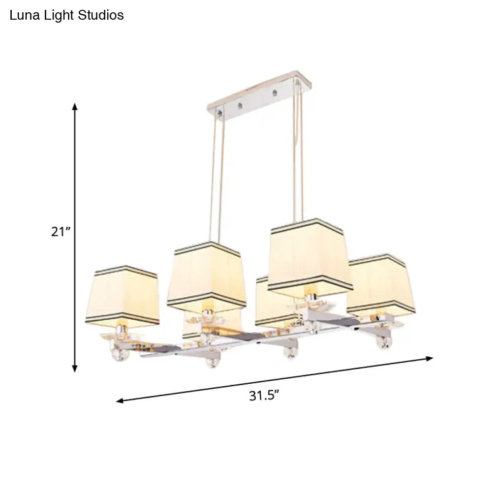 Modern chrome island pendant light with cream shades for dining rooms