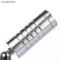 Silver cylindrical magnetic keychain with segmented ribbed design showcasing modern chrome mini tubed wall lamp white warm lighting