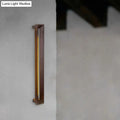 A modern dark brown wooden led wall sconce with a sleek frame and warm yellow vertical illumination for study rooms